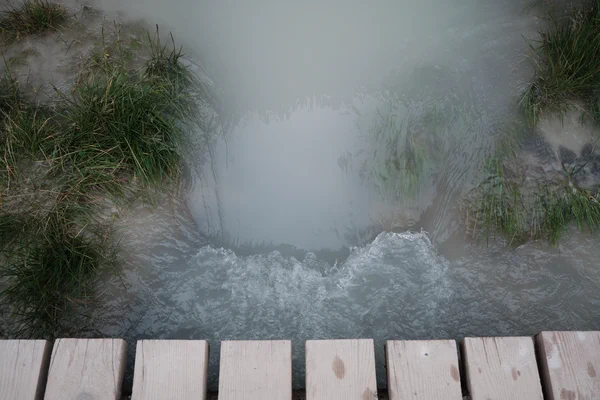 Cloudy summer glacial runoff flowing into glacier lake.